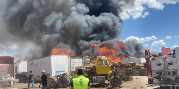 Incendio en bodega clandestina de tarimas en Pozos